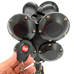 Hand with BossHorn remote control in front of DeWalt Train Horn