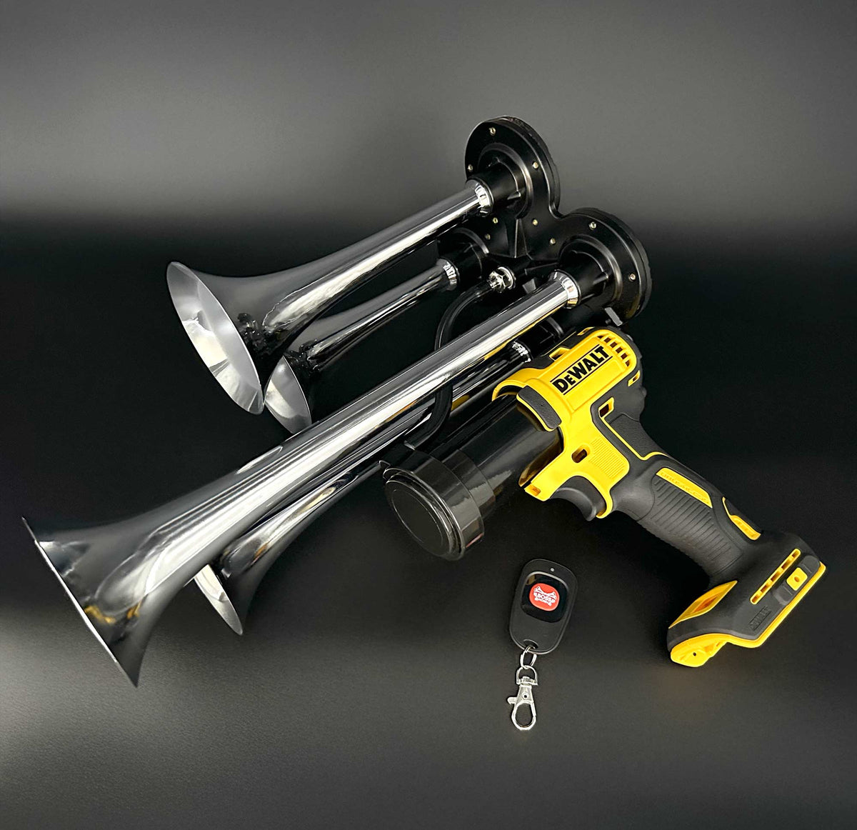DeWalt Train Horn with chrome trumpets and remote control laying on black background