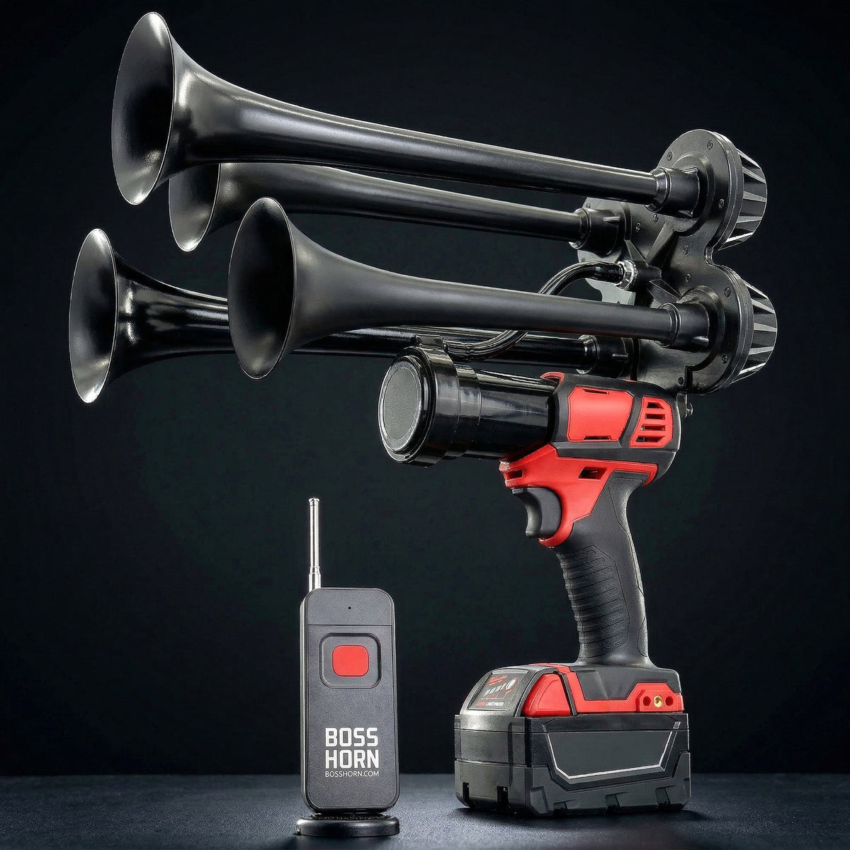 Black air horn system with red and black power drill and remote control on a dark background
