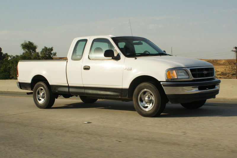 White pickup truck parked on a paved road