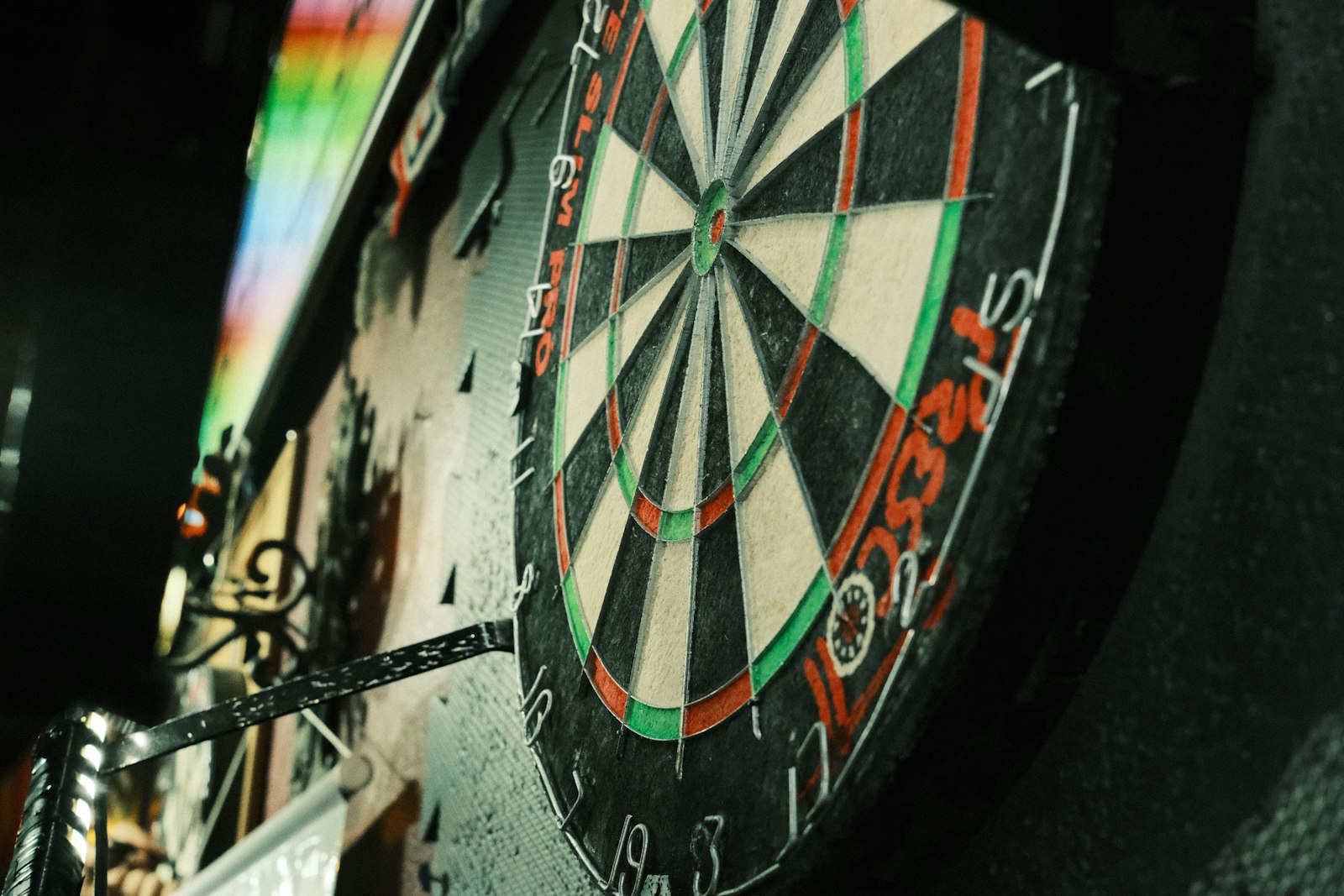 A dartboard mounted on a wall in a cozy game room, the kind of man cave hangout where a loud horn makes a fun centerpiece