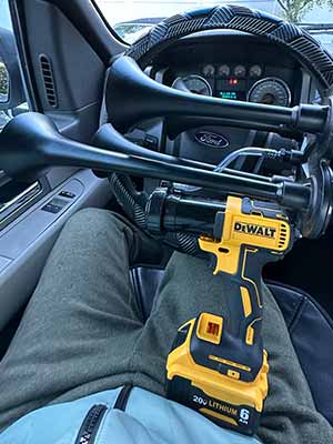pov guy with Dewalt Train Horn sits in the car
