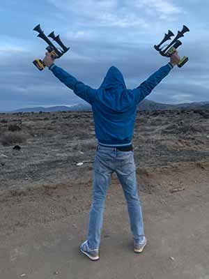 Man with two horns. Dewalt Train Horn in left hand aimed into the top