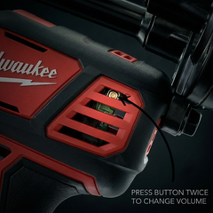 Close-up of a Milwaukee device with a red and black design on a dark background.